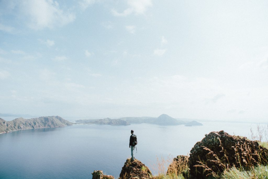 Photo of person at mountain top of Padar Island Summit